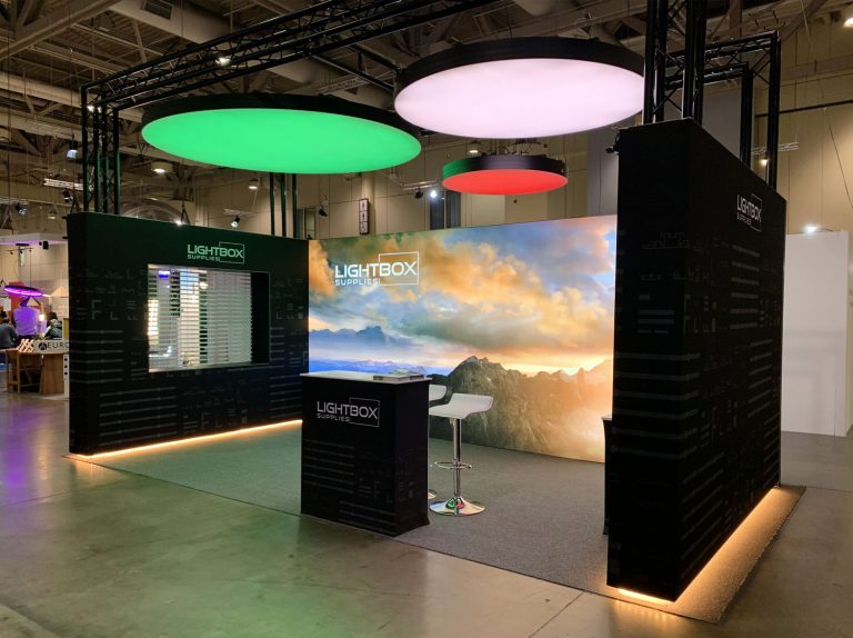 Medium sized booth using LED lightboxes for walls, and lumi ceiling products